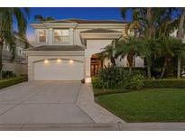 Elegant two-story home with a three-car garage, lush landscaping, and a welcoming front entrance at 926 Anchorage Rd, Tampa, FL 33602
