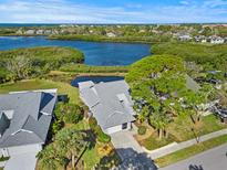 Beautiful waterfront home with mature trees and water views at 1020 Lake Avoca Dr, Tarpon Springs, FL 34689