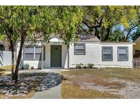 Charming single-story home featuring a well-maintained lawn, and a welcoming front door with the house number above at 304 E Hanlon St, Tampa, FL 33604