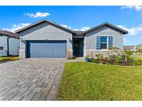 Charming single-Gathering home with a well-manicured lawn and inviting curb appeal on a sunny day at 34244 Radley Way, Wesley Chapel, FL 33545