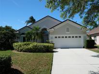 Charming single-story home featuring a two-car garage and well-manicured landscaping at 6504 Virginia Xing, University Park, FL 34201