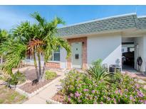 Charming single-story home with a well-manicured front yard and lush tropical landscaping at 7755 39Th N Ave, St Petersburg, FL 33709