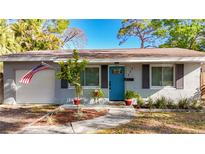 Charming single-story home features a manicured front yard and an inviting blue front door at 777 62Nd N Ave, St Petersburg, FL 33702