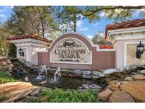Elegant Coachman Reserve entrance sign with water feature and manicured landscaping at 891 Lantern Way # 13-103, Clearwater, FL 33765