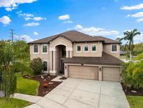 Stunning two-story home with a three-car garage, manicured lawn, and beautiful landscaping at 9402 59Th N St, Pinellas Park, FL 33782