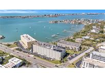 A beautiful aerial view of the condo complex overlooking the ocean with sailboats in the distance at 100 Bluff View Dr # 614A, Belleair Bluffs, FL 33770