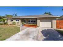 Charming single-story home featuring a well-manicured lawn, attached garage, and neutral color scheme at 160 Avon Dr, Safety Harbor, FL 34695