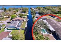Beautiful waterfront home featuring a private pool and canal access, surrounded by lush landscaping at 3105 S Canal Dr, Palm Harbor, FL 34684