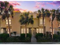 Inviting townhome exterior with palm trees and lush landscaping at sunset at 5100 Burchette Rd # 3403, Tampa, FL 33647
