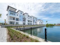 Waterfront condos feature a blue and white exterior, balconies, and stunning water views at 5351 Bridge St # 99, Tampa, FL 33611