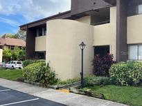 Condominium exterior features manicured landscaping and a well-maintained facade at 730 S Village N Dr # 101, St Petersburg, FL 33716