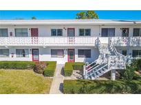 Charming condo building with well-maintained landscaping and a bright, welcoming facade at 8325 112Th St # 202, Seminole, FL 33772