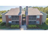 Brick exterior of two-story condo with screened balconies and manicured landscaping in a waterfront community at 9100 Dr Martin Luther King Jr N St # 405, St Petersburg, FL 33702