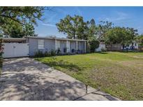 Charming single-story home with a well-manicured lawn, driveway, and landscaping at 1211 E Camellia Dr., Brandon, FL 33510