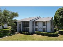 Well maintained condo building with mature trees and landscaping at 1337 Pine Ridge E Cir # D2, Tarpon Springs, FL 34688