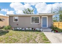 Charming single-story home with light blue door and neutral siding, surrounded by landscaping at 2726 25Th N Ave, St Petersburg, FL 33713