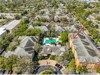 Aerial view showcasing the complex, a refreshing pool, lush landscaping, and convenient parking at 4207 S Dale Mabry Hwy # 2412, Tampa, FL 33611
