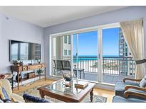 Bright living room with ocean view through sliding glass doors leading to balcony at 1180 Gulf Blvd # 1604, Clearwater Beach, FL 33767