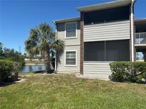 A charming condo featuring an outdoor screened patio and a serene view of the community pond at 1400 Gandy N Blvd # 305, St Petersburg, FL 33702