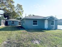 Charming single-story home with gray paint, white trim, well-maintained lawn, and detached garage at 1409 Franklin St, Clearwater, FL 33756