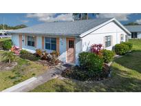 Charming single story home with well-maintained landscaping and peach accents at 1902 Andover St # 198, Sun City Center, FL 33573