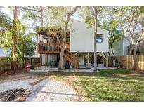 Large backyard shows patio, outdoor grill, fire pit, and deck perfect for entertaining guests at 314 Ontario Ave, Crystal Beach, FL 34681