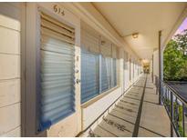 Hallway view of the exterior featuring a covered walkway and adjacent parking at 4152 56Th N Way # 614, Kenneth City, FL 33709