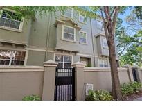 Inviting townhome with neutral colors and landscaping; featuring a charming gated entrance and well-maintained facade at 7240 102Nd Ln, Seminole, FL 33772
