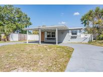 Charming single-story home featuring a covered front porch and a spacious front yard at 10309 108Th Ave, Largo, FL 33773