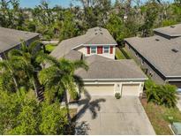 Lovely home featuring a three-car garage, and a lush yard with mature palms at 10315 Riverdale Rise Dr, Riverview, FL 33578