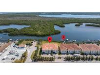 Aerial view of waterfront condos with boat docks and lush green surroundings at 1076 Paseo Del Rio Ne, St Petersburg, FL 33702