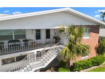 Inviting two-story condo building with brick accents, stair access, and manicured landscaping at 330 Brandy Wine Dr # 330, Largo, FL 33771