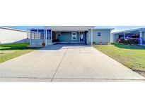 Charming single-story home featuring a covered carport, well-maintained lawn, and a welcoming entrance at 37530 Corey Lewis Ave, Zephyrhills, FL 33541