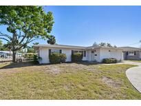 Charming single-story home with a well-maintained lawn and mature landscaping at 5167 Venetian Ne Blvd, St Petersburg, FL 33703