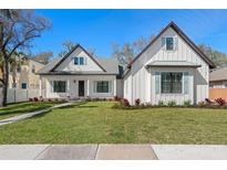 Charming two-story home with a lush green lawn and attractive modern farmhouse details at 0 Old Country Rd, Odessa, FL 33556