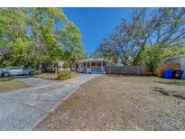 Charming single-story home with a welcoming front porch and long driveway at 2340 Kingston S St, St Petersburg, FL 33711