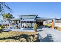 Charming single-story home with a spacious driveway and well-maintained landscaping at 37235 Cora Ave, Zephyrhills, FL 33542