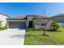 Charming single-story home with well-maintained lawn and attached two-car garage at 5412 Olano St, Palmetto, FL 34221
