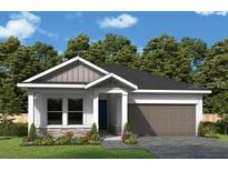 Charming single-Gathering home with a well-manicured lawn, inviting entrance, and attached garage at 10640 Crescent Creek Xing, Parrish, FL 34219