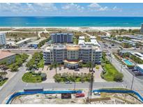 Expansive aerial view of a beachfront condo complex with manicured landscaping and ocean views at 11605 Gulf Blvd # 404, Treasure Island, FL 33706
