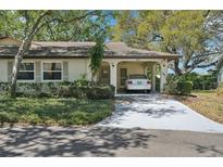 Charming single-story home featuring a covered carport and manicured landscaping at 2009 Halidom Way, Sun City Center, FL 33573