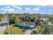 Charming one-story home with light blue exterior, green grass and palm trees at 311 Ravenna N St # 3, Nokomis, FL 34275