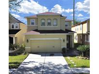 Charming two-story home featuring a well-manicured lawn, two car garage, and inviting curb appeal at 31730 Spoonflower Cir, Wesley Chapel, FL 33545