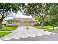 Charming single-story villa with a two-car garage and manicured front lawn at 34907 Double Eagle Ct, Zephyrhills, FL 33541