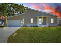 Charming single-story home features a modern design, well-manicured lawn, and an attached two-car garage at 3860 Whiting Se Dr, St Petersburg, FL 33705