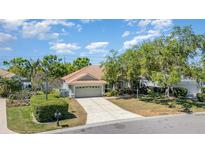 Charming single-story home with a tile roof, two-car garage, and well-maintained landscaping at 7581 Palmer Glen Cir, Sarasota, FL 34240