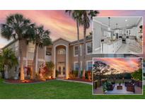 Stunning two-story home boasting lush landscaping, mature palms, and a warm, inviting exterior at 15618 Shoal Creek Pl, Odessa, FL 33556