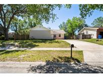 Charming single-Gathering home with a spacious front yard and a long driveway at 18406 Sterling Silver Cir, Lutz, FL 33549