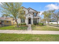Charming two-story home features well-manicured lawn and beautiful landscaping at 216 N Habana Ave, Tampa, FL 33609