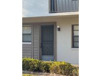 The front of the unit features a secure screen door and updated lighting fixture at 3046 Eastland Blvd # J106, Clearwater, FL 33761